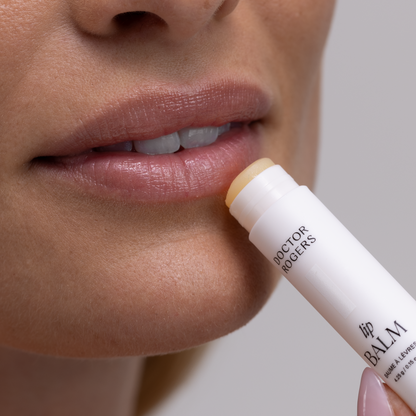 Woman applying Doctor Rogers Restore Lip Balm on lips to heal dry chapped lips quickly